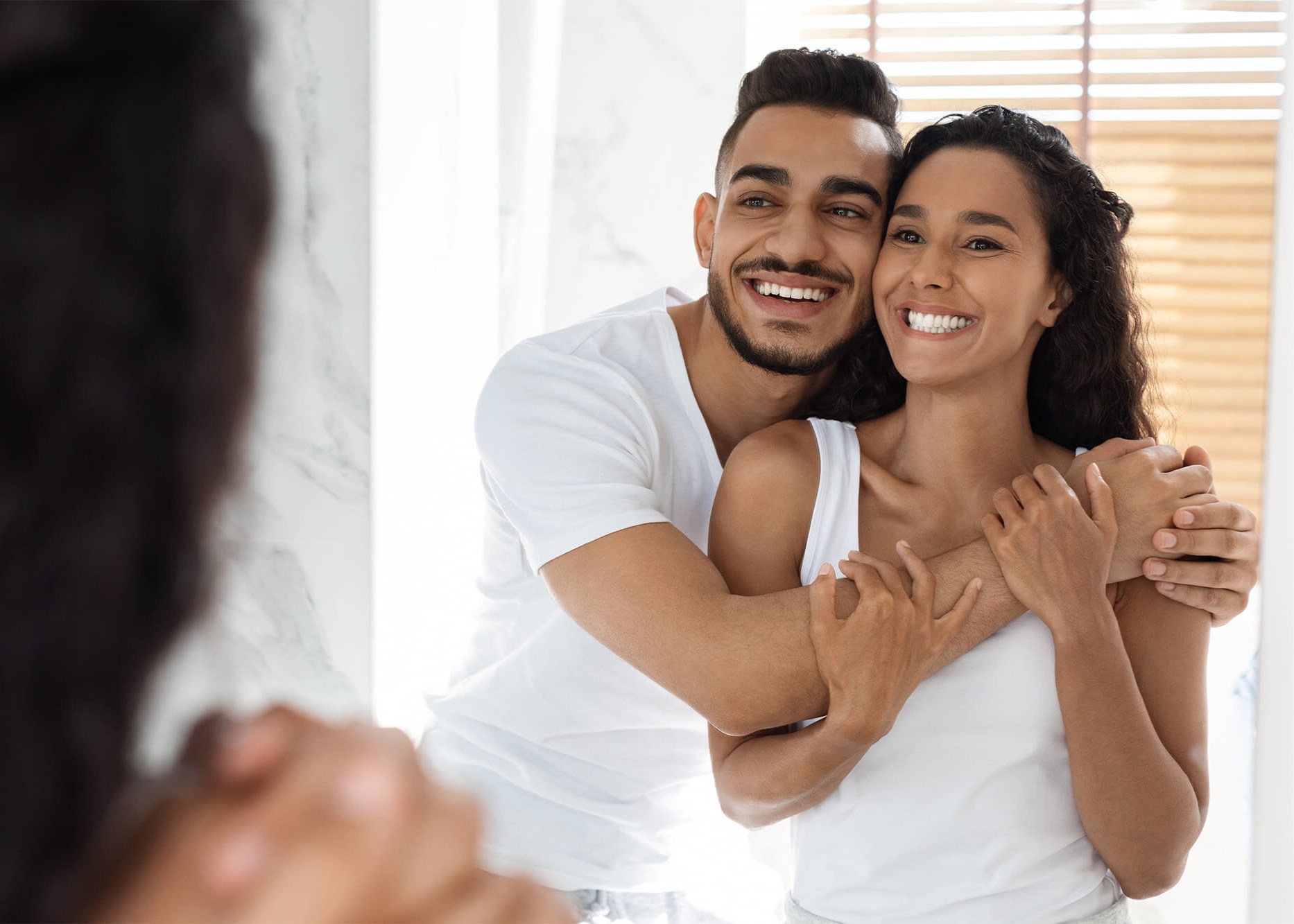 couple looking in mirror smiling
